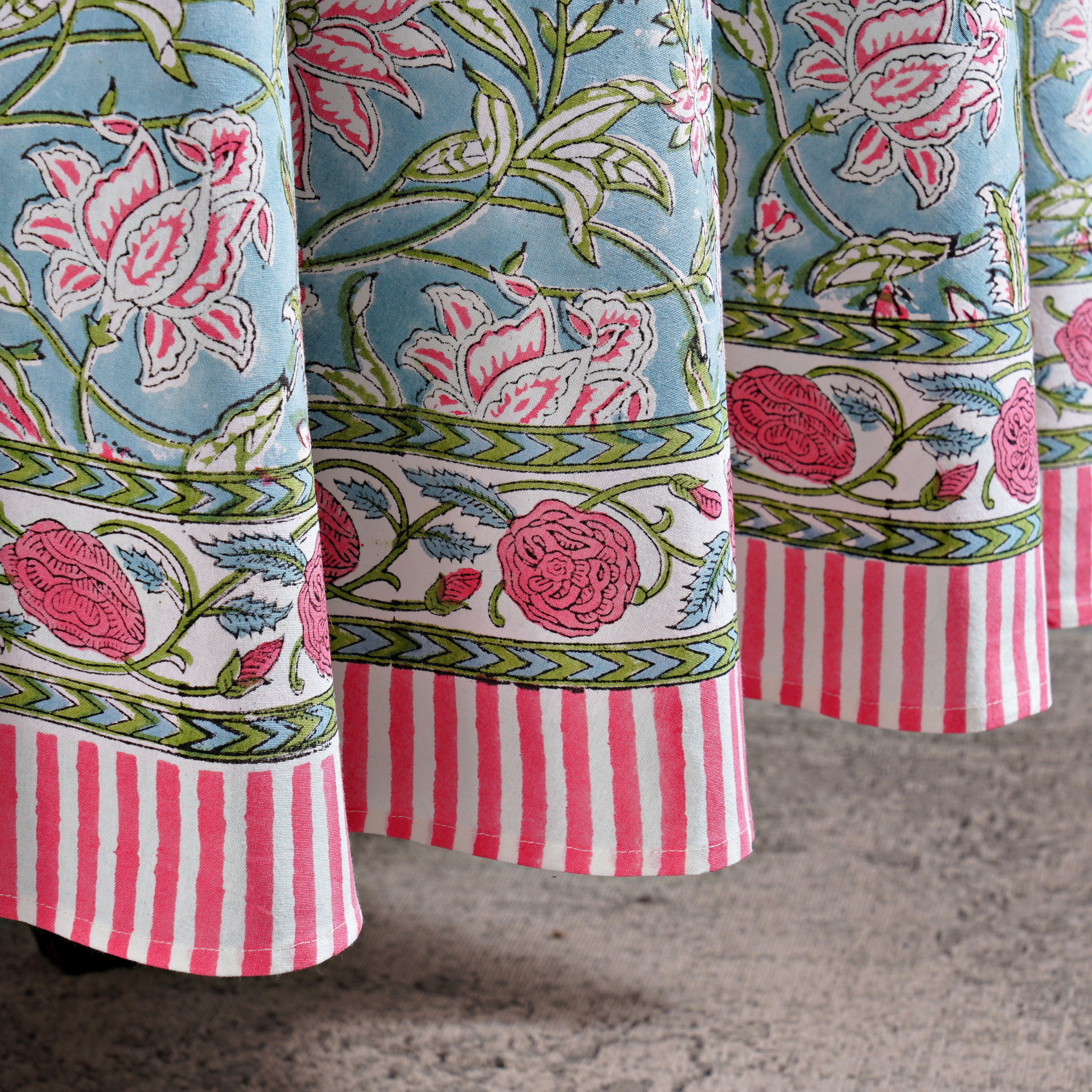 Close-up of patterned fabric with floral and striped designs.