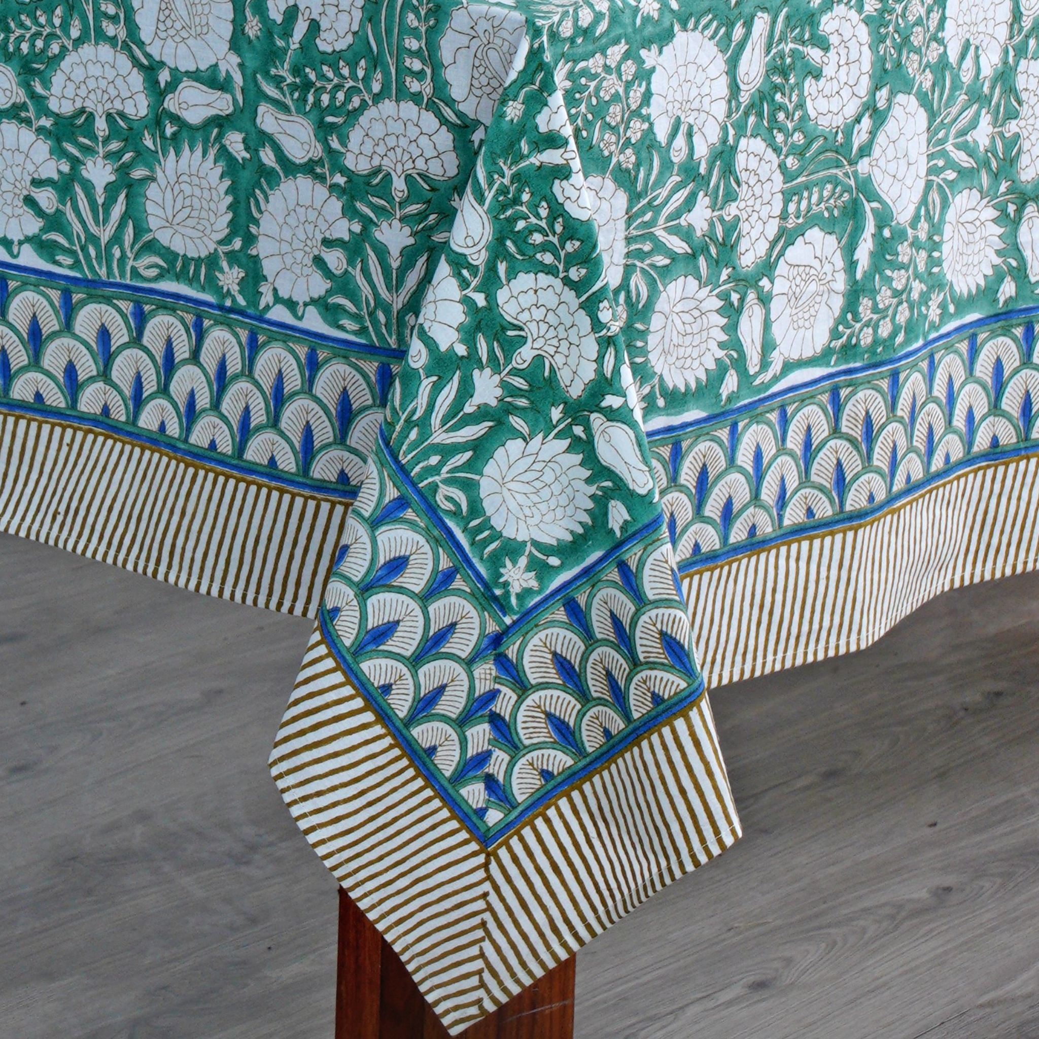 Decorative tablecloth with floral pattern on a wooden table