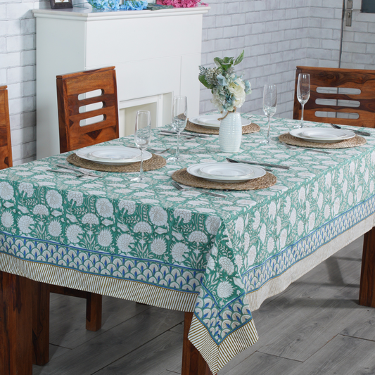 Dining table set with a floral tablecloth in a home setting