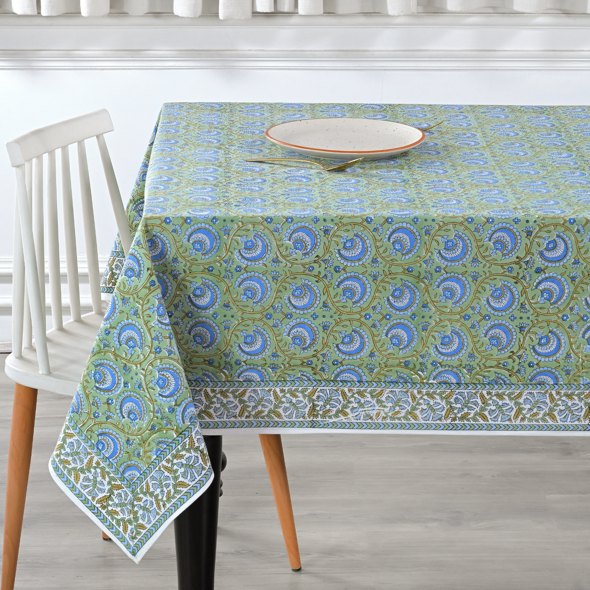 Tablecloth with a green and blue pattern on a dining table