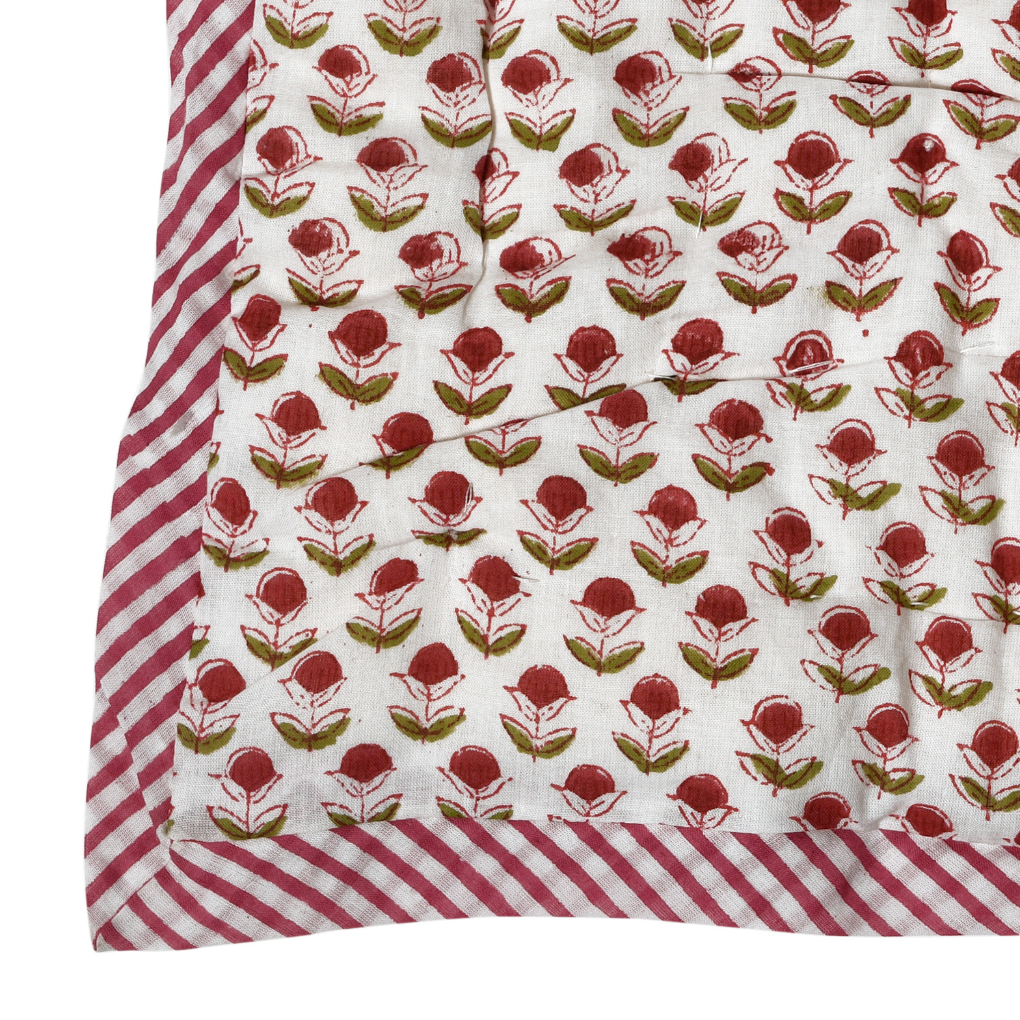 Floral patterned fabric with red and green flowers on a white background, bordered by red and white striped fabric.
