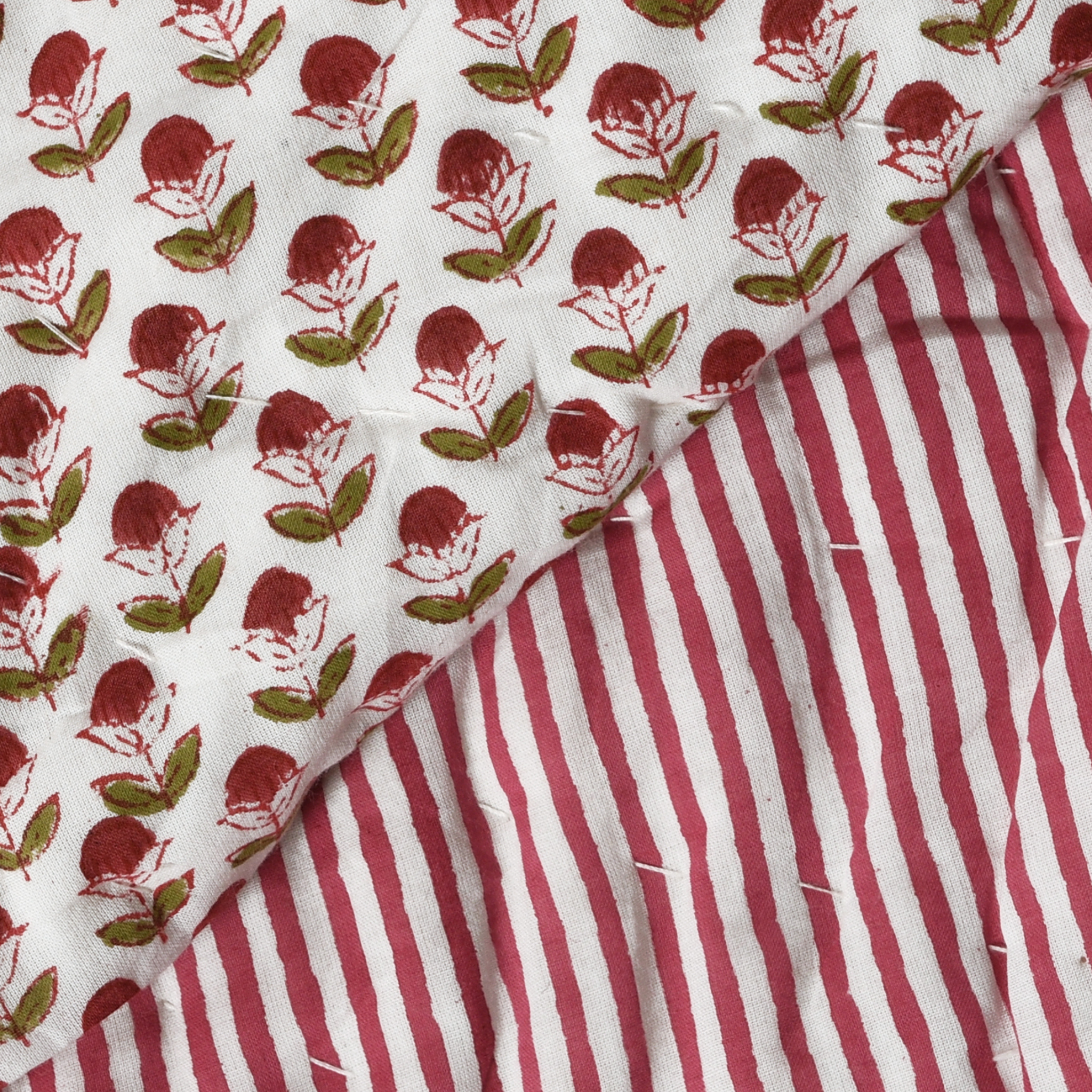 Two fabric swatches with floral pattern and red and white stripes.