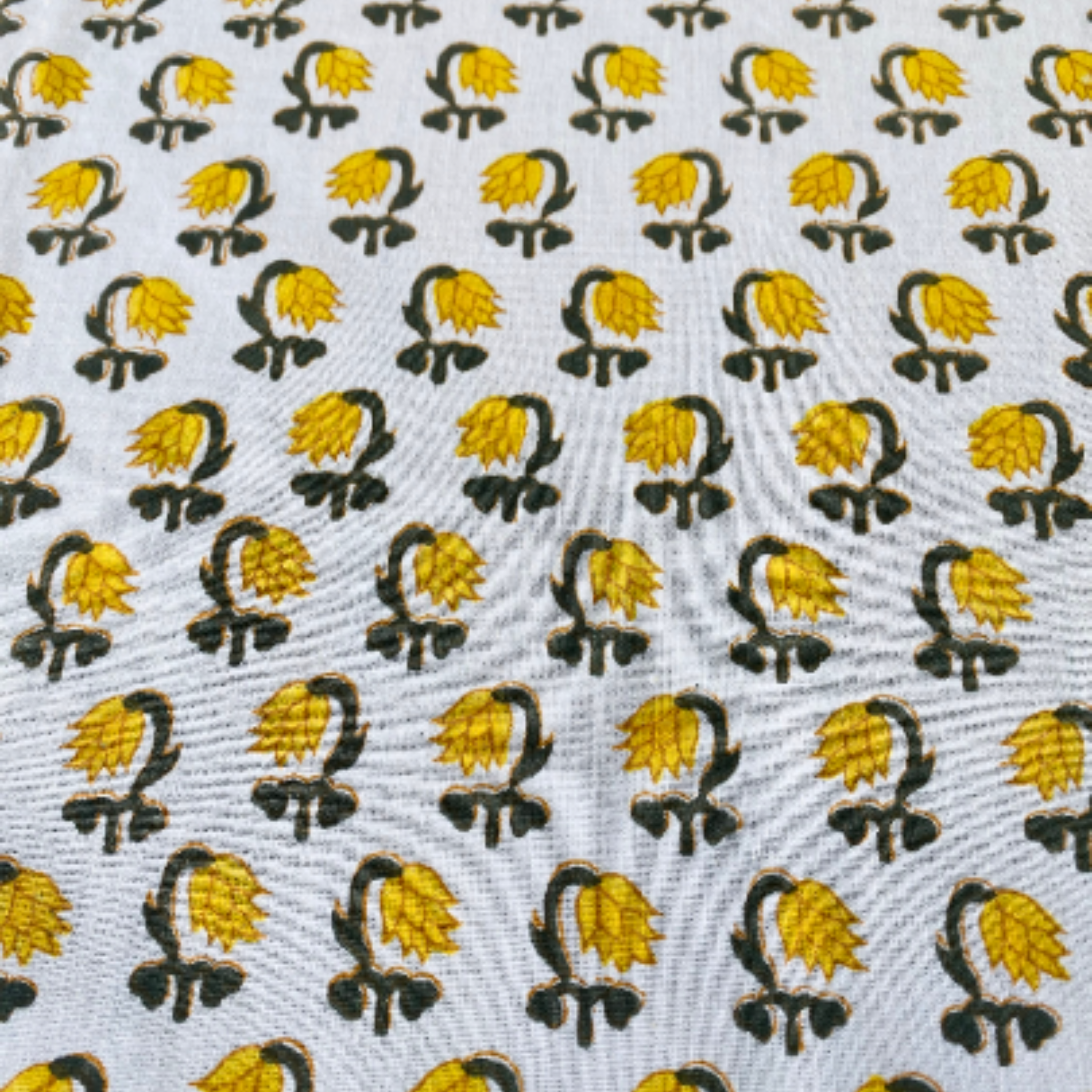 Patterned fabric with yellow and black designs on a white background