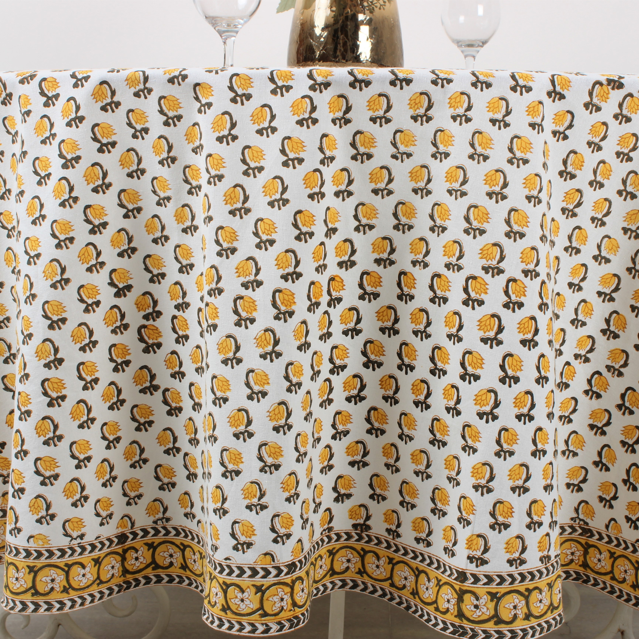Tablecloth with yellow and black floral pattern on a white background