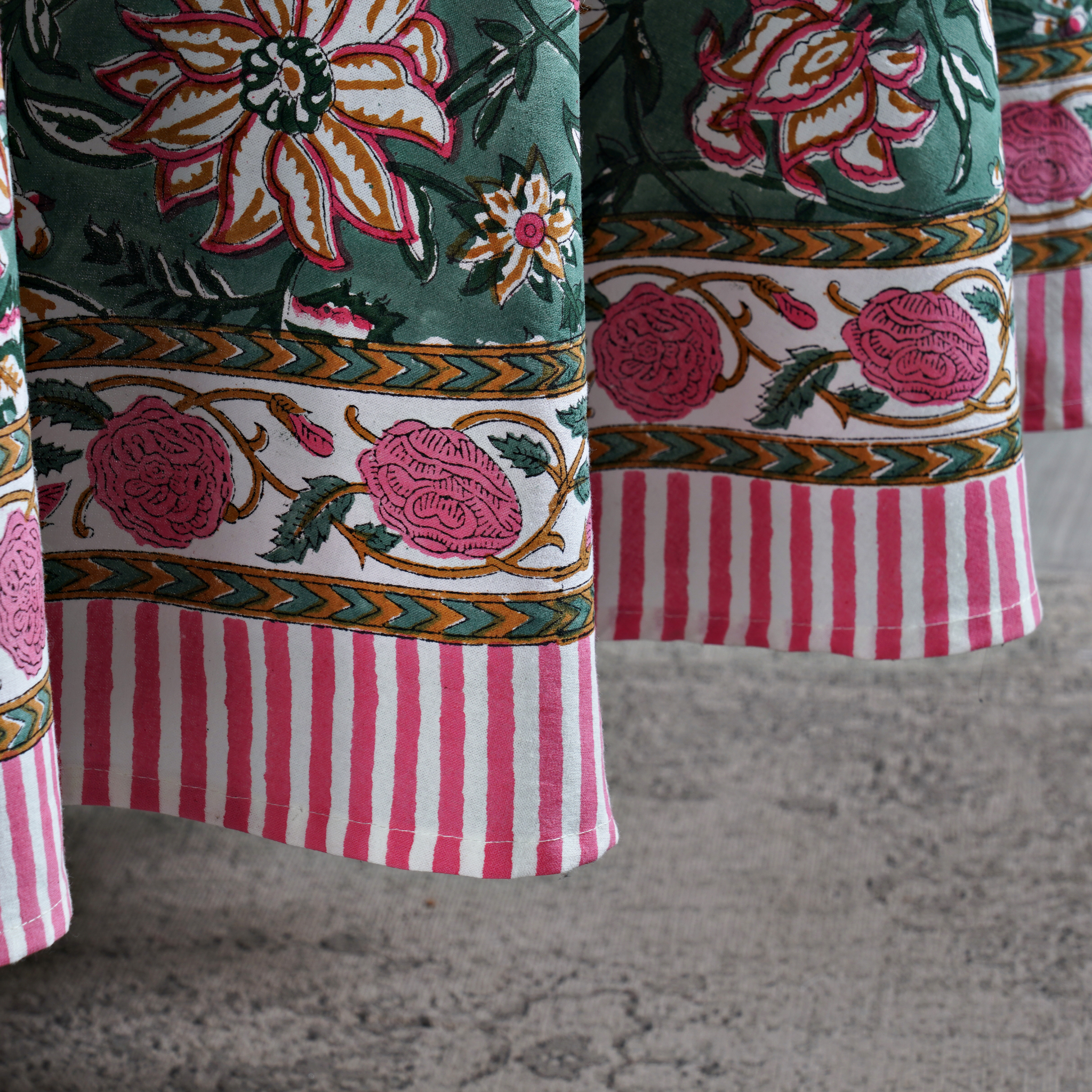 Close-up of a fabric with floral and striped patterns on a textured surface.