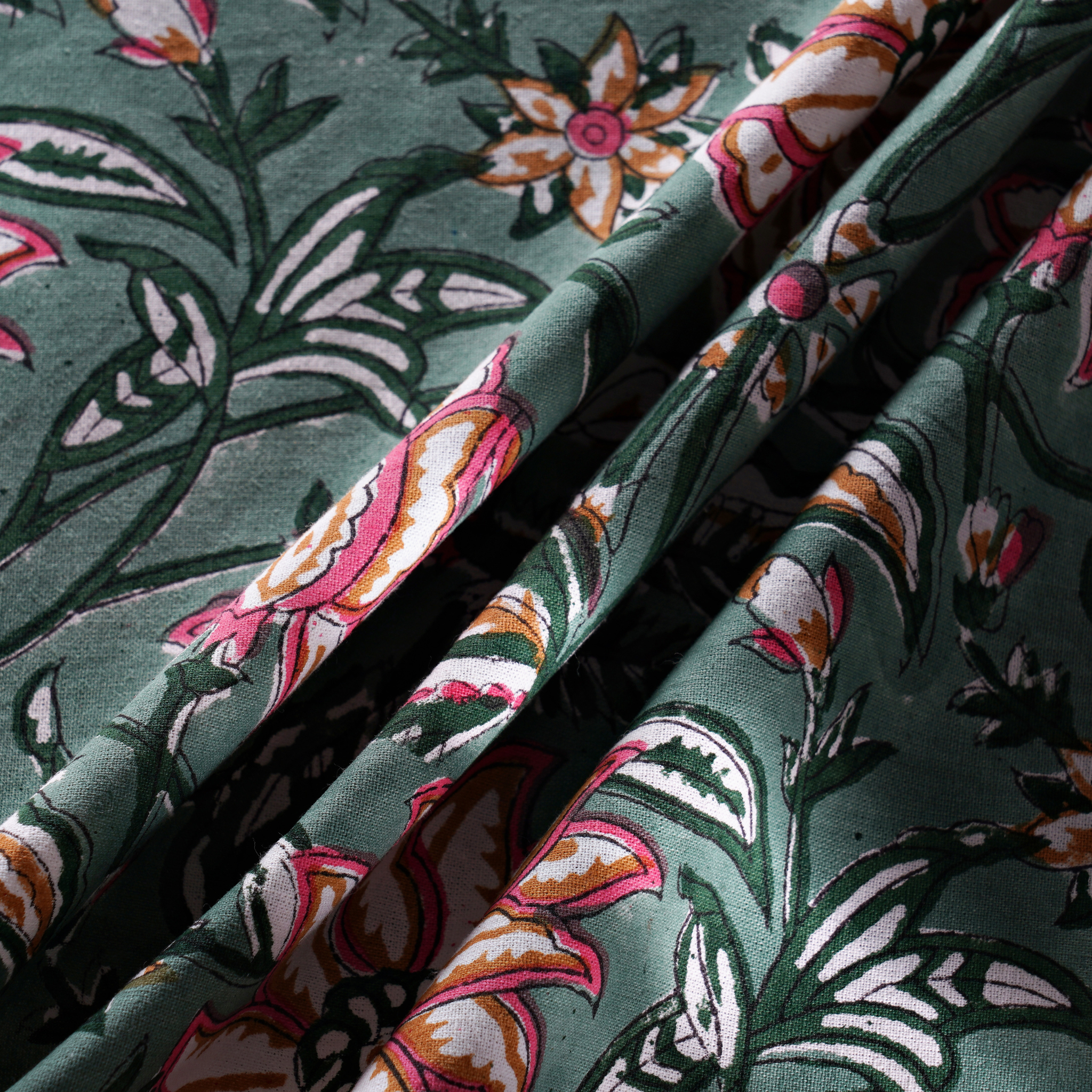 Close-up of floral fabric with green background