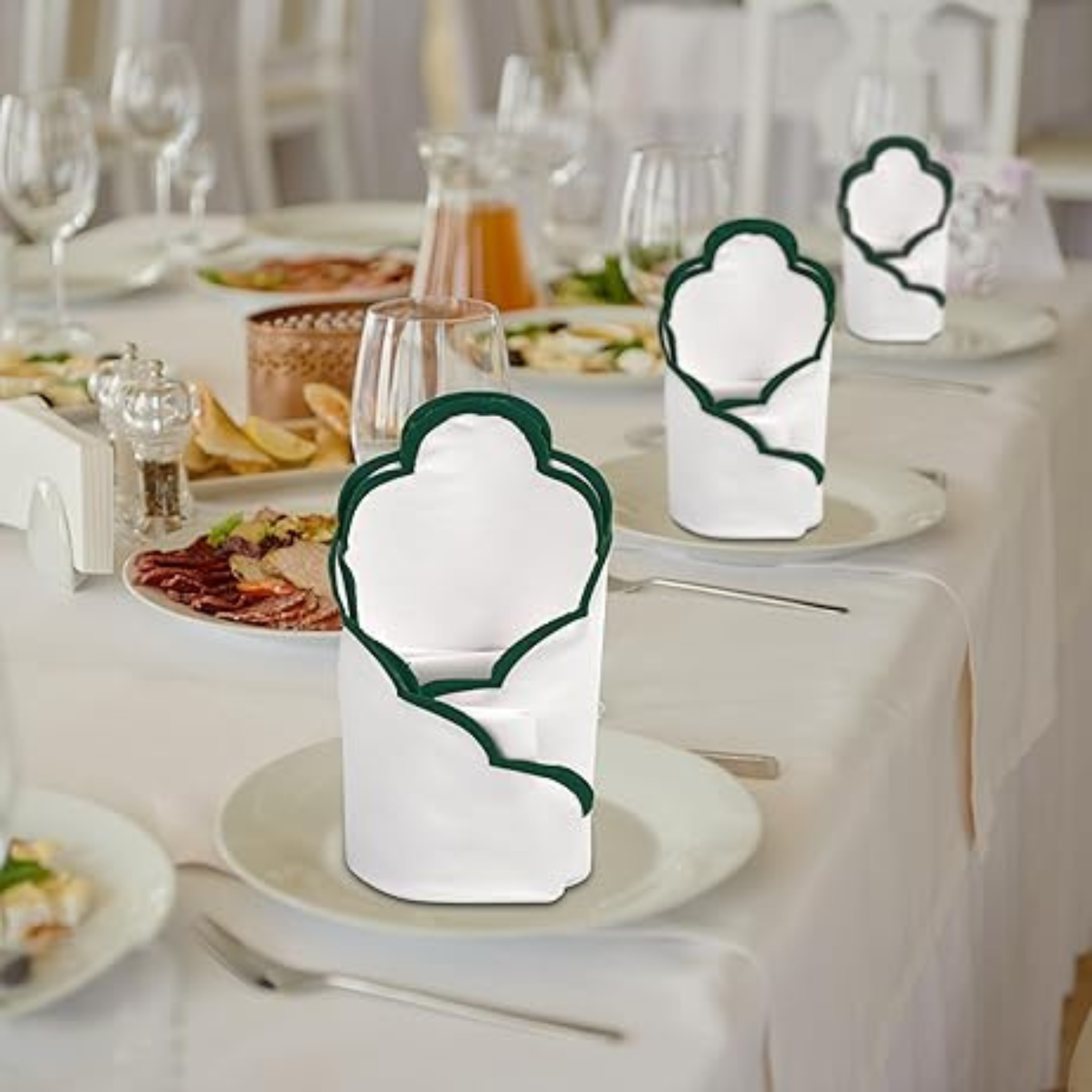 White napkin holders with green trim on a table setting.