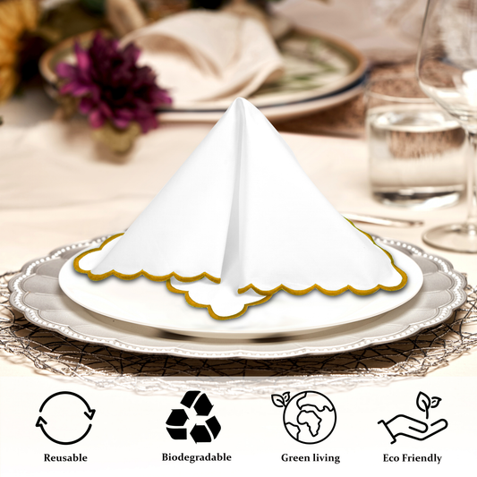 White scalloped napkin holder on a decorative plate with table setting in the background