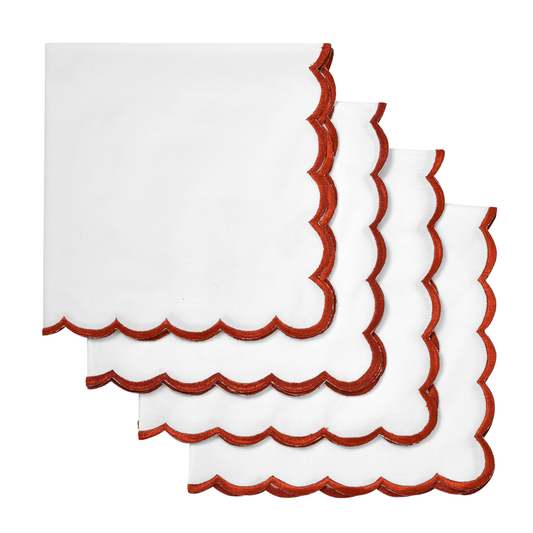 White napkins with red scalloped edges on a white background