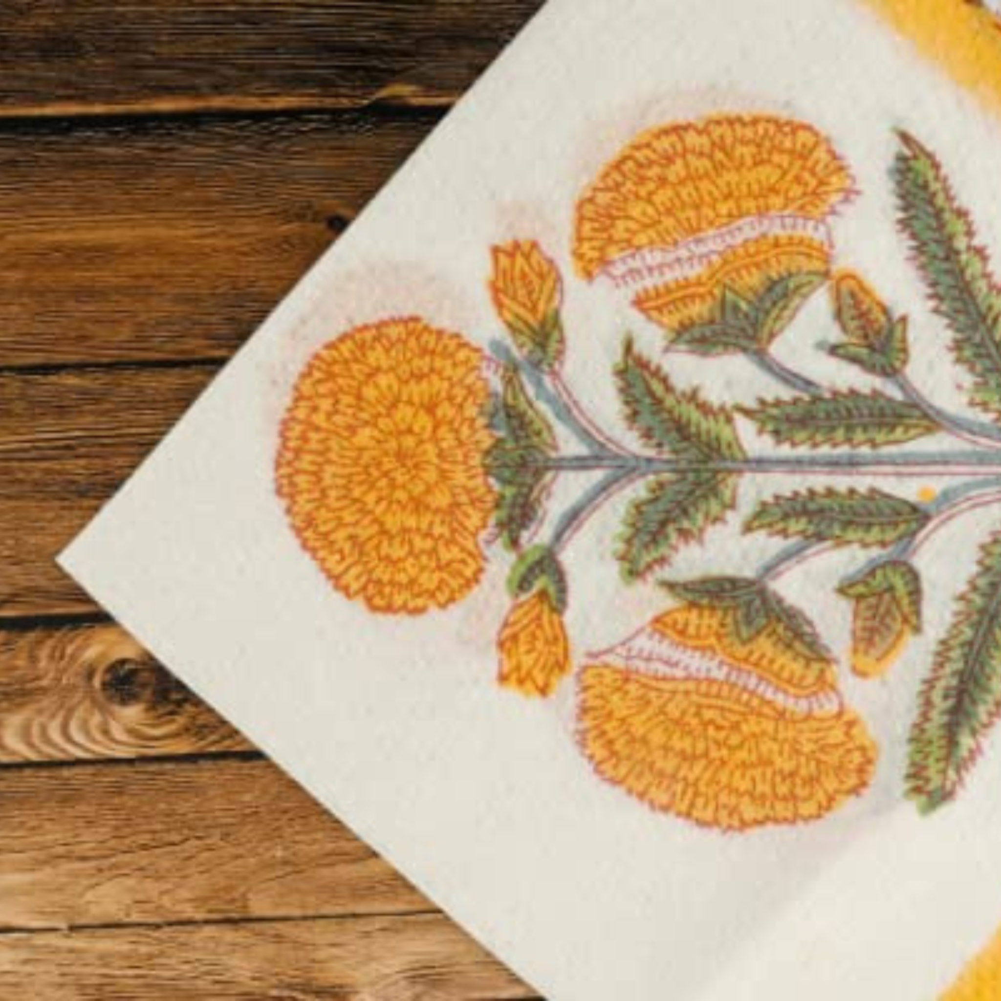 Embroidered fabric with floral pattern on a wooden surface