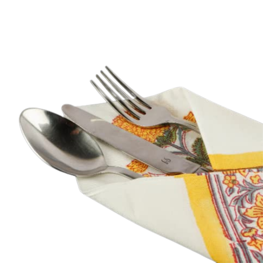 Silverware set on a patterned napkin with a white background