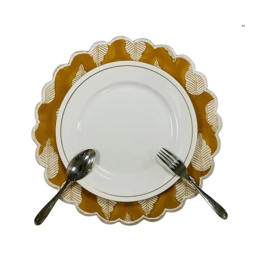 White plate with gold decorative rim, accompanied by a spoon and fork on a white background