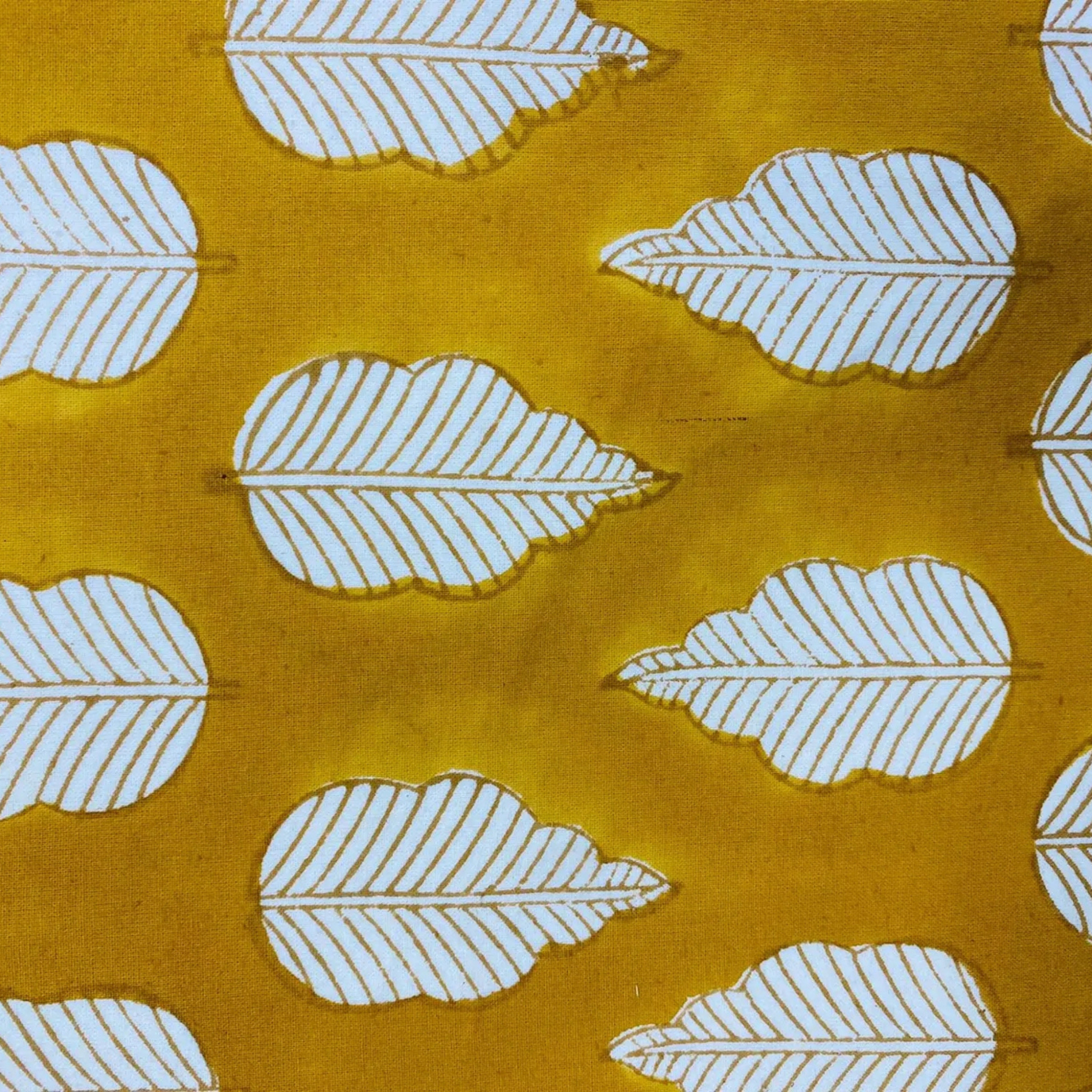 White leaf pattern on a mustard yellow background